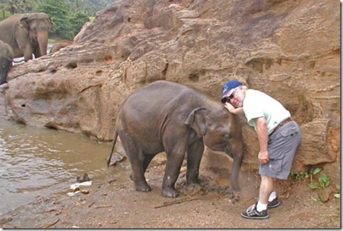 Photo of Charles Carmona Petting Baby Elephant
