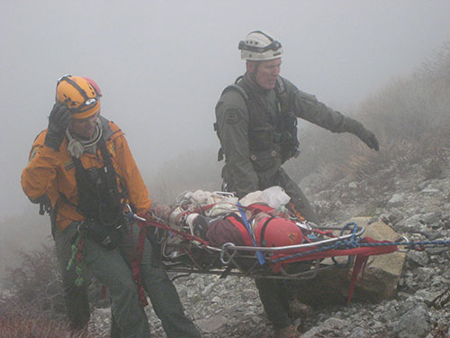 Photo of Mike Leum Making a Rescue on the Side of a Mountain