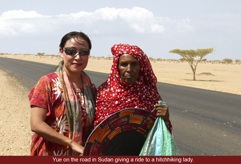 Yue Chi on the Road in Sudan giving a ride to a hitchhiking lady