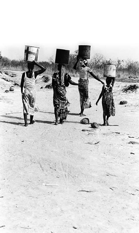 Photo of Villagers Carrying Water
