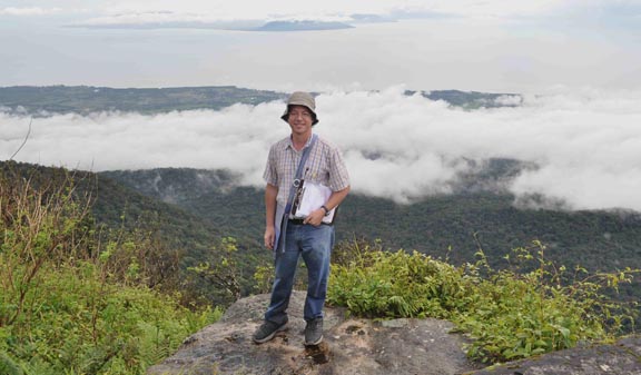 Photo of Daniel Robinson atop Bokor Hill Station in Cambodia, with the Vietnamese island of Phu Quoc in the background