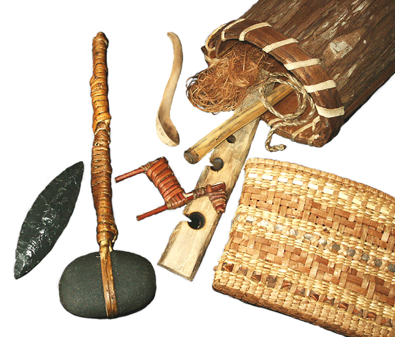 Various tools.  Obsidian biface, stone hammer, willow deer hunting effigy, West Coast style spoon, handdrill fire set, dogbane fiber, stinging nettle cordage, cedar bark berry basket, and basket of cedar and rushes.