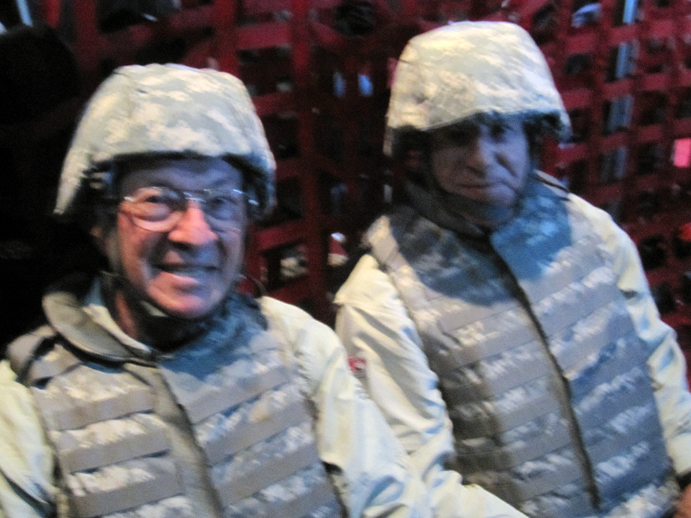 Photo of Nissen Davis and Mario Andretti in full battle dress inside a USAF C-130 en route to Joint Base Balud, Iraq
